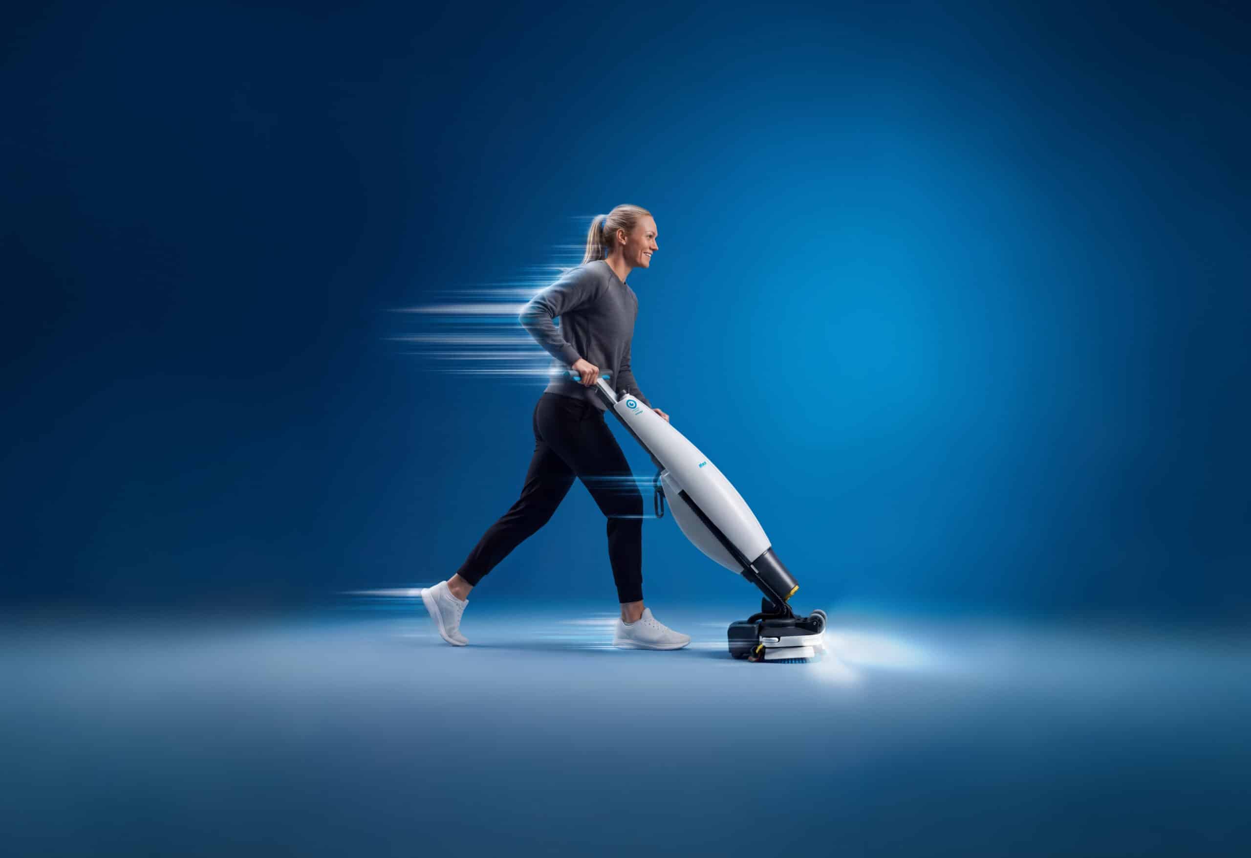 Cleaner walking upright while using the i-team i-mop 46 floor scrubber